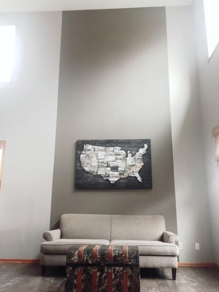 Accentuate and create interest in a two-story wall. Maps are very meaningful and can inspire. 